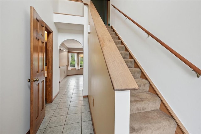5020 Meadow Crest Dr, Hampton, PA 15101 - staircase with arched walkways, tile patterned floors, and baseboards