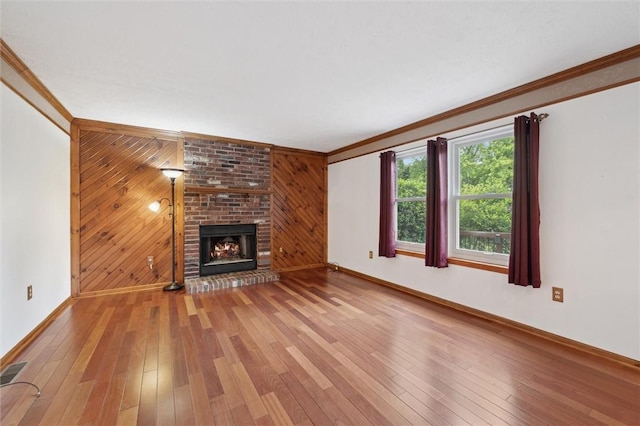 5020 Meadow Crest Dr, Hampton, PA 15101 - unfurnished living room featuring ornamental molding, baseboards, hardwood / wood-style floors, a fireplace, and wooden walls
