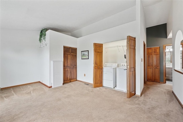 5020 Meadow Crest Dr, Hampton, PA 15101 - unfurnished bedroom with washing machine and dryer, light colored carpet, baseboards, ensuite bathroom, and high vaulted ceiling