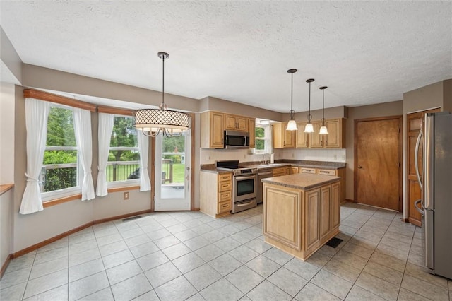 5020 Meadow Crest Dr, Hampton, PA 15101 - kitchen featuring stainless steel appliances, a center island, baseboards, a textured ceiling, and a sink
