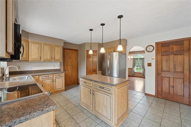 5020 Meadow Crest Dr, Hampton, PA 15101 - kitchen featuring freestanding refrigerator, a sink, light tile patterned floors, tasteful backsplash, and a center island