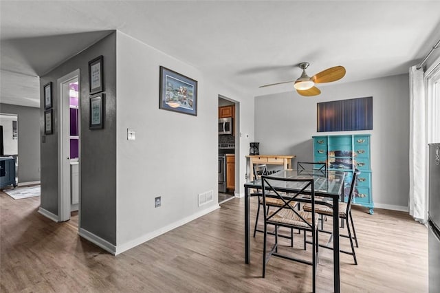 65 Universal St, Bridgeville, PA 15017 - dining room with ceiling fan, wood finished floors, and baseboards
