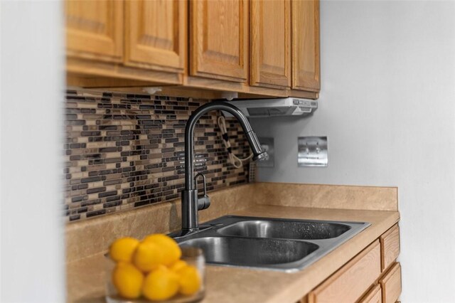 65 Universal St, Bridgeville, PA 15017 - kitchen view of a sink, backsplash, and light countertops