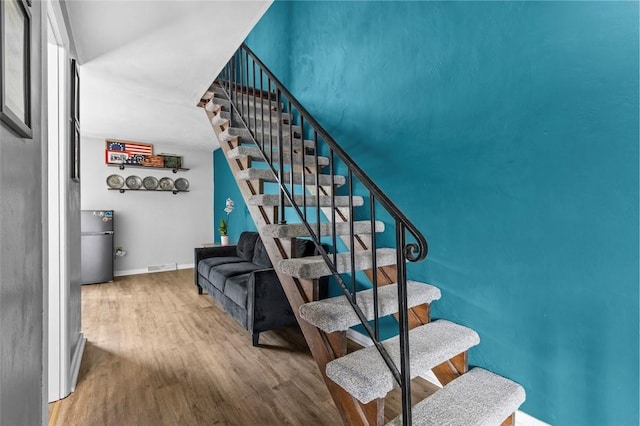 65 Universal St, Bridgeville, PA 15017 - stairway featuring wood finished floors and baseboards
