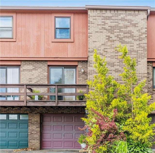 65 Universal St, Bridgeville, PA 15017 - view of front of property with brick siding, a balcony, and a garage