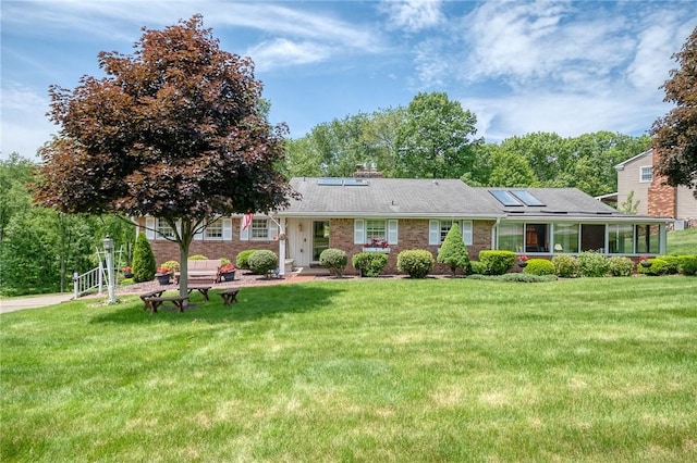 117 Glenfield Dr, Brighton Twp, PA 15009 - single story home featuring roof mounted solar panels, a front yard, and brick siding