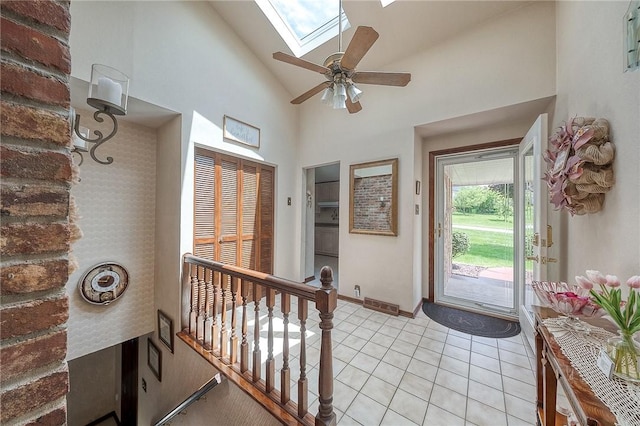 117 Glenfield Dr, Brighton Twp, PA 15009 - foyer with a skylight, high vaulted ceiling, light tile patterned floors, ceiling fan, and baseboards