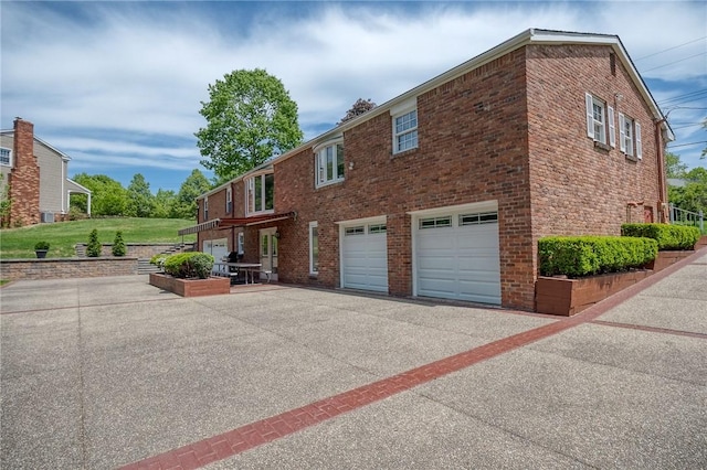 117 Glenfield Dr, Brighton Twp, PA 15009 - view of side of home with brick siding, a garage, and driveway