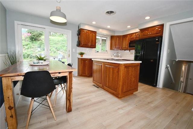 303 Larch Ln, Baldwin Twp, PA 15234 - kitchen with black appliances, light wood finished floors, light countertops, brown cabinets, and recessed lighting