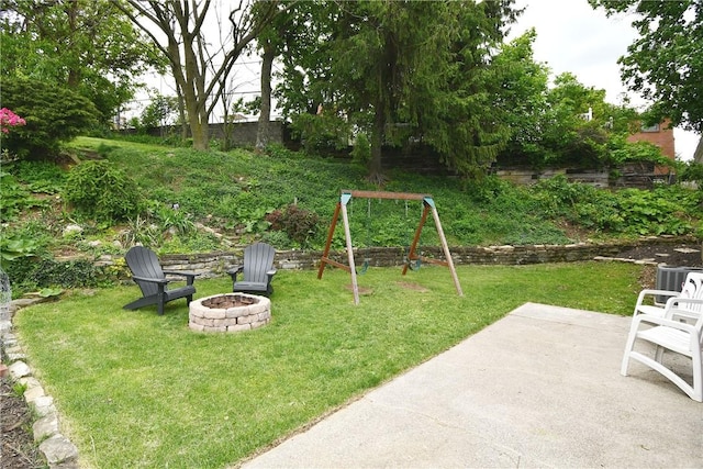 303 Larch Ln, Baldwin Twp, PA 15234 - view of green lawn with an outdoor fire pit, a patio area, and a playground