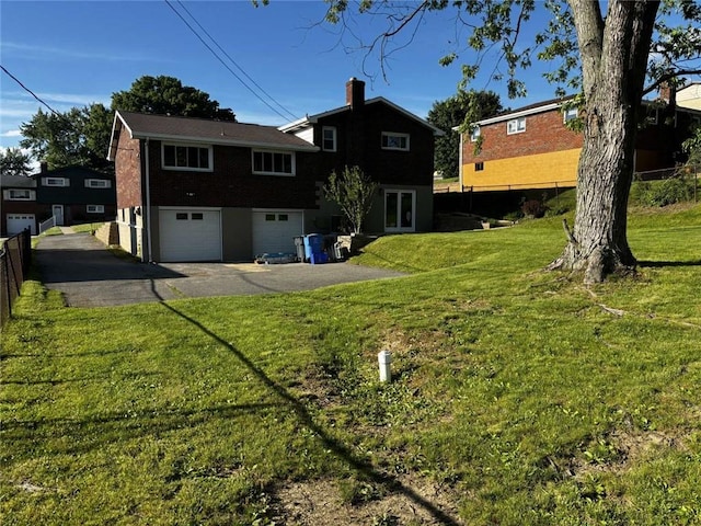 1123 Blue Jay Dr, Pittsburgh, PA 15243 - back of property with driveway, an attached garage, a yard, and brick siding
