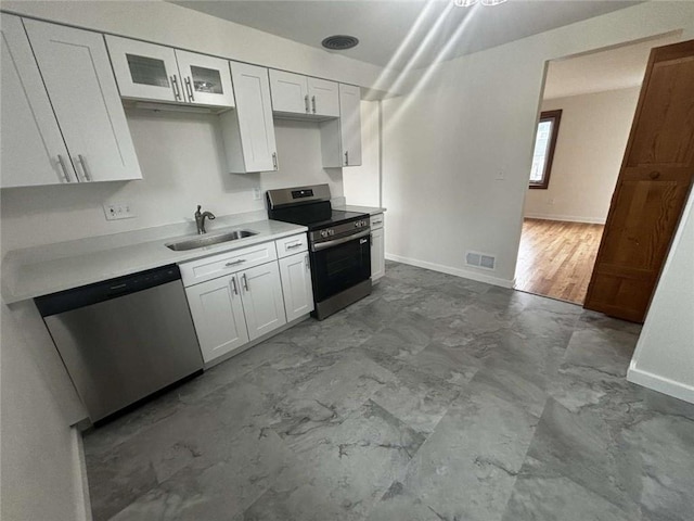 1123 Blue Jay Dr, Pittsburgh, PA 15243 - kitchen featuring stainless steel appliances, a sink, baseboards, marble look tile flooring, and white cabinetry