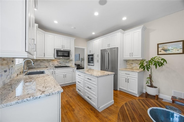 230 Summerlawn Dr, Bell Acres, PA 15143 - kitchen featuring a sink, stainless steel appliances, backsplash, white cabinetry, and recessed lighting