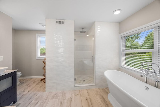 230 Summerlawn Dr, Bell Acres, PA 15143 - full bathroom featuring a shower stall, vanity, a freestanding tub, wood finished floors, and toilet
