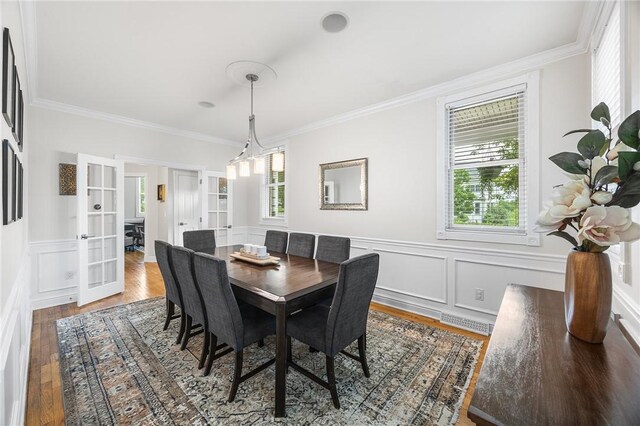230 Summerlawn Dr, Bell Acres, PA 15143 - dining space featuring crown molding, wood finished floors, wainscoting, french doors, and a decorative wall