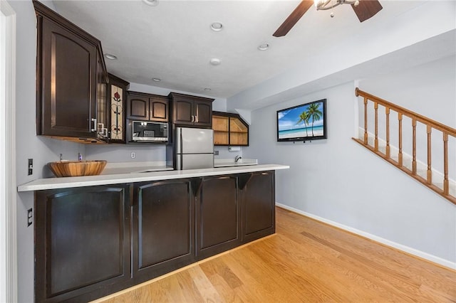 230 Summerlawn Dr, Bell Acres, PA 15143 - kitchen featuring appliances with stainless steel finishes, a peninsula, a ceiling fan, light wood finished floors, and dark brown cabinetry