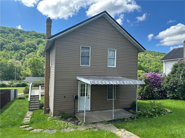 1081 Dixon Rd, Cherryhll Twp/Clymer, PA 15728 - back of property featuring a chimney, a lawn, a patio area, stairs, and a view of trees