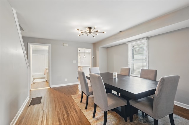 848 7th St, Verona, PA 15147 - dining area with a chandelier, wood finished floors, and baseboards