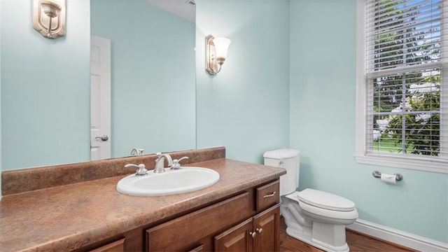203 Providence Ct, Adams Twp, PA 16059 - half bathroom featuring toilet, wood finished floors, vanity, and baseboards