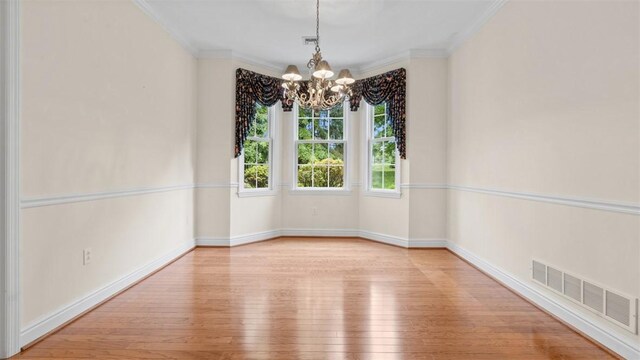 203 Providence Ct, Adams Twp, PA 16059 - unfurnished room featuring wood-type flooring, a chandelier, ornamental molding, and baseboards