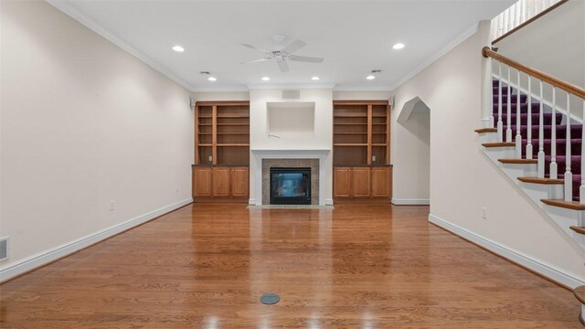 203 Providence Ct, Adams Twp, PA 16059 - unfurnished living room with ceiling fan, stairway, wood finished floors, crown molding, and a fireplace