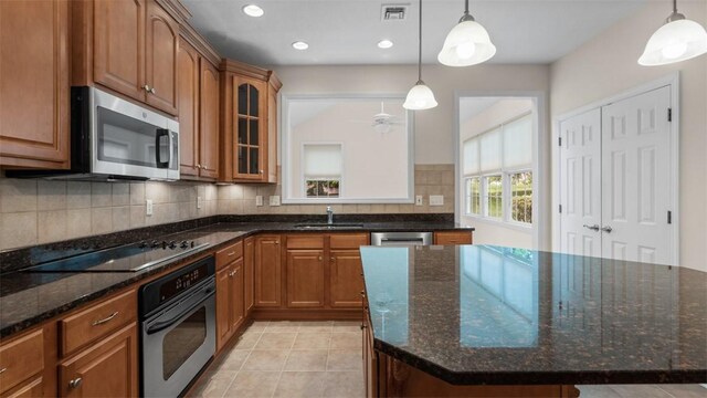 203 Providence Ct, Adams Twp, PA 16059 - kitchen with appliances with stainless steel finishes, a sink, brown cabinets, glass insert cabinets, and tasteful backsplash