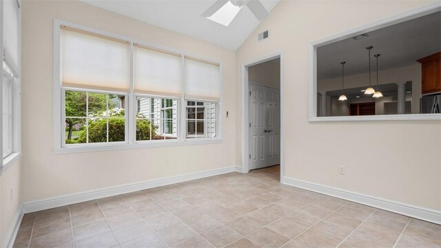 203 Providence Ct, Adams Twp, PA 16059 - spare room with a skylight, vaulted ceiling, light tile patterned flooring, baseboards, and ceiling fan