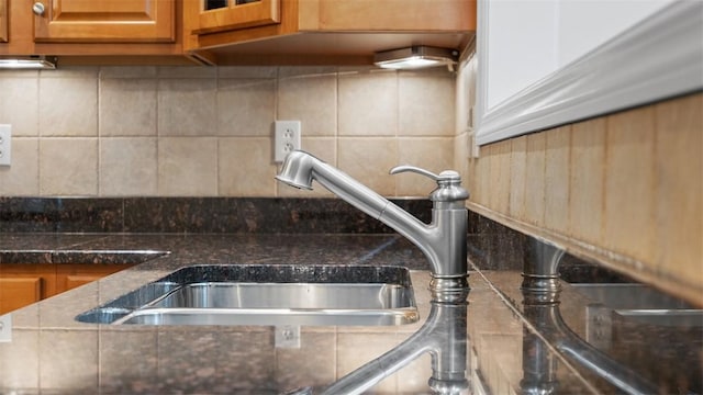 203 Providence Ct, Adams Twp, PA 16059 - detailed view of a sink, brown cabinetry, and decorative backsplash