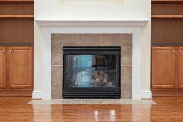 203 Providence Ct, Adams Twp, PA 16059 - detailed view of a tile fireplace and wood finished floors