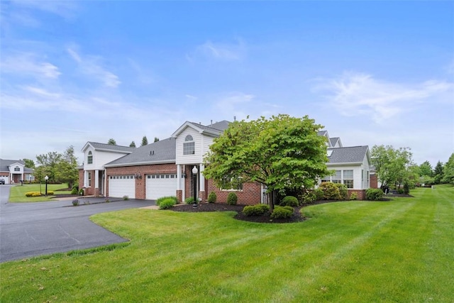 203 Providence Ct, Adams Twp, PA 16059 - view of front of property with an attached garage, brick siding, a front lawn, and asphalt driveway