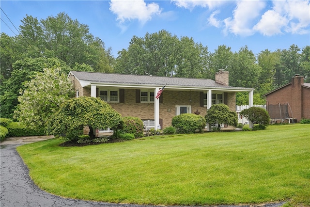 146 Tower Ln, Daugherty Twp, PA 15066 - bi-level home featuring a front yard, brick siding, and a chimney