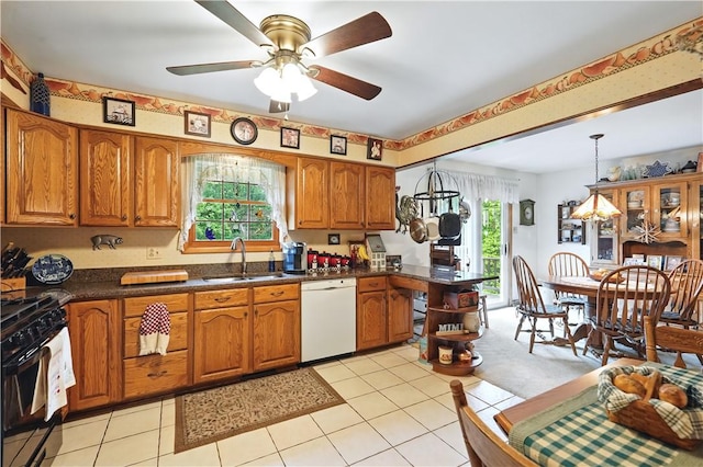 146 Tower Ln, Daugherty Twp, PA 15066 - kitchen featuring black range with gas cooktop, dishwasher, brown cabinetry, a ceiling fan, and dark countertops