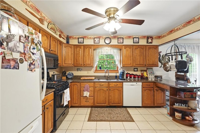 146 Tower Ln, Daugherty Twp, PA 15066 - kitchen featuring black appliances, a sink, brown cabinets, ceiling fan, and a peninsula