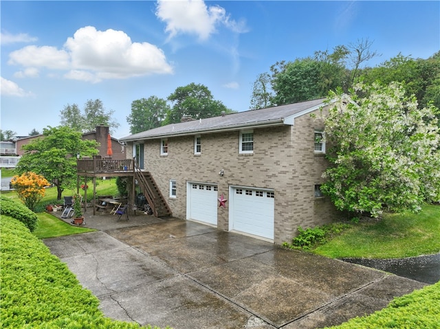 146 Tower Ln, Daugherty Twp, PA 15066 - view of side of property featuring stairway, a garage, a deck, driveway, and brick siding