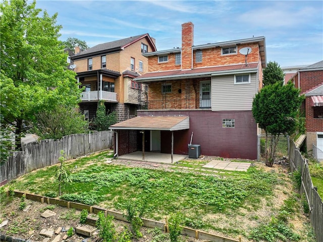 2352 Edgar St, Carrick, PA 15210 - back of property with brick siding, a patio, a chimney, and central AC unit