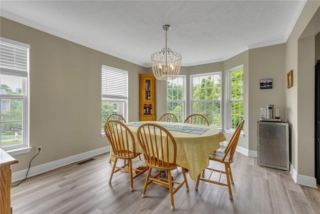 6023 Hawthorn Dr, Moon/Crescent Twp, PA 15108 - dining area featuring a chandelier, plenty of natural light, light wood-style flooring, baseboards, and crown molding