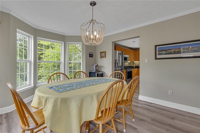 6023 Hawthorn Dr, Moon/Crescent Twp, PA 15108 - dining space with baseboards, a chandelier, light wood-type flooring, plenty of natural light, and ornamental molding