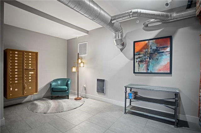 622 Gross St Unit 104, Bloomfield, PA 15224 - living area with baseboards, tile patterned floors, and heating unit