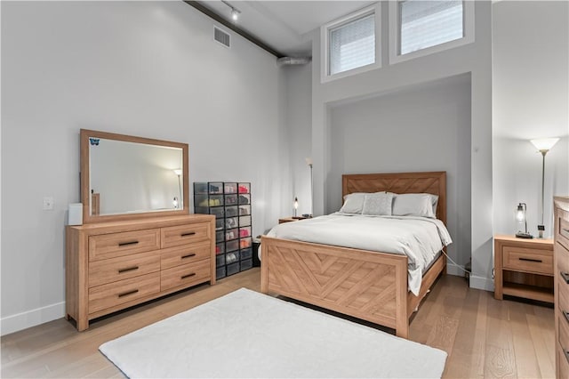 622 Gross St Unit 104, Bloomfield, PA 15224 - bedroom featuring a high ceiling, light wood finished floors, and baseboards