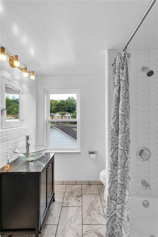 623 E 3rd Ave, Tarentum, PA 15084 - full bathroom with vanity, marble finish floors, shower / bath combination with curtain, and healthy amount of natural light