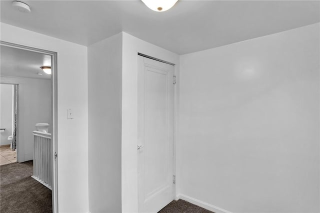 623 E 3rd Ave, Tarentum, PA 15084 - unfurnished bedroom featuring dark carpet, baseboards, and a closet