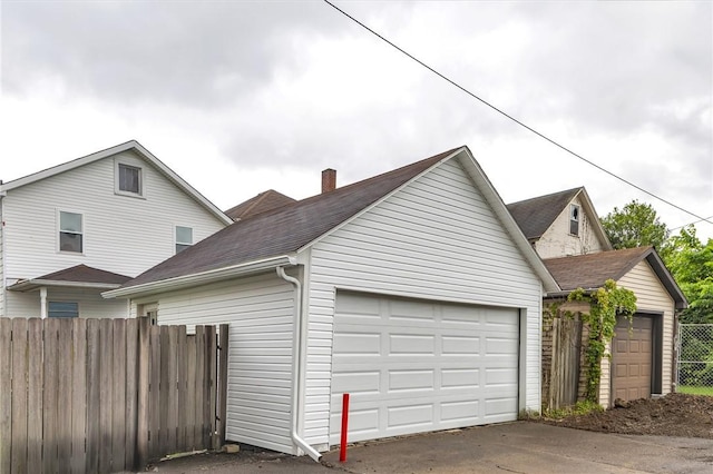 623 E 3rd Ave, Tarentum, PA 15084 - view of home's exterior featuring an outdoor structure, a chimney, and roof with shingles