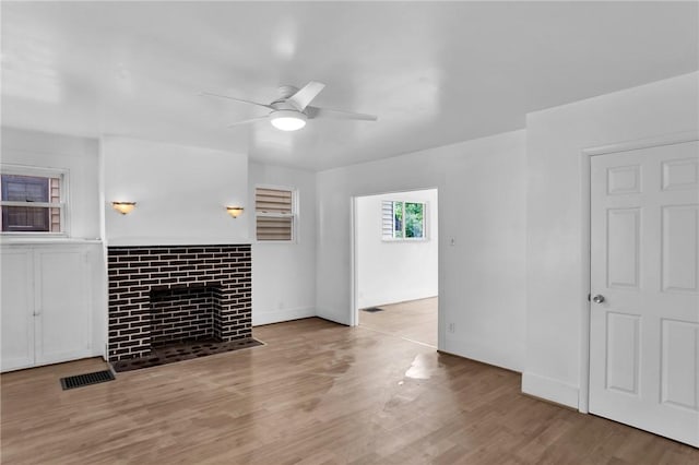 623 E 3rd Ave, Tarentum, PA 15084 - unfurnished living room featuring a ceiling fan, wood finished floors, a tile fireplace, and baseboards
