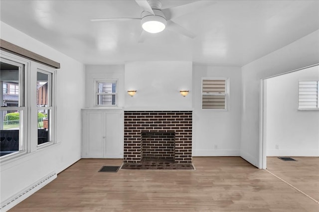 623 E 3rd Ave, Tarentum, PA 15084 - unfurnished living room featuring a baseboard radiator, ceiling fan, wood finished floors, and a fireplace