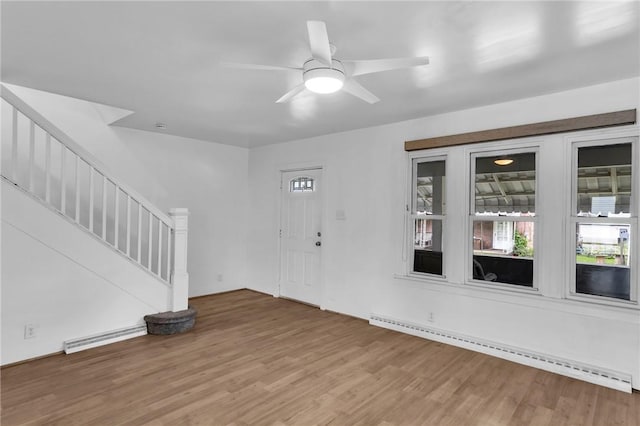 623 E 3rd Ave, Tarentum, PA 15084 - foyer featuring a baseboard radiator, stairway, and wood finished floors
