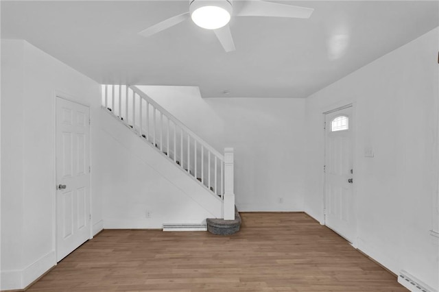 623 E 3rd Ave, Tarentum, PA 15084 - foyer featuring stairway, ceiling fan, a baseboard radiator, and wood finished floors