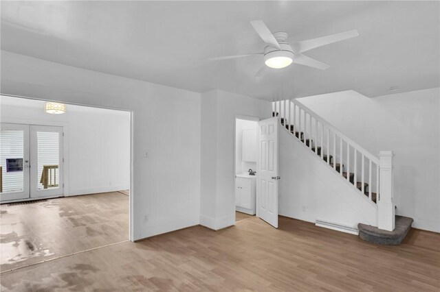 623 E 3rd Ave, Tarentum, PA 15084 - unfurnished living room featuring stairway, wood finished floors, french doors, a ceiling fan, and baseboards