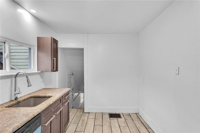 623 E 3rd Ave, Tarentum, PA 15084 - kitchen with a sink, dishwashing machine, light wood finished floors, baseboards, and dark brown cabinets