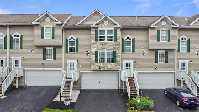 215 Mountain Dr, Carnegie, PA 15106 - view of front of house with stairs, stone siding, and driveway