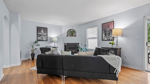 215 Mountain Dr, Carnegie, PA 15106 - living room featuring wood finished floors, a fireplace, and baseboards